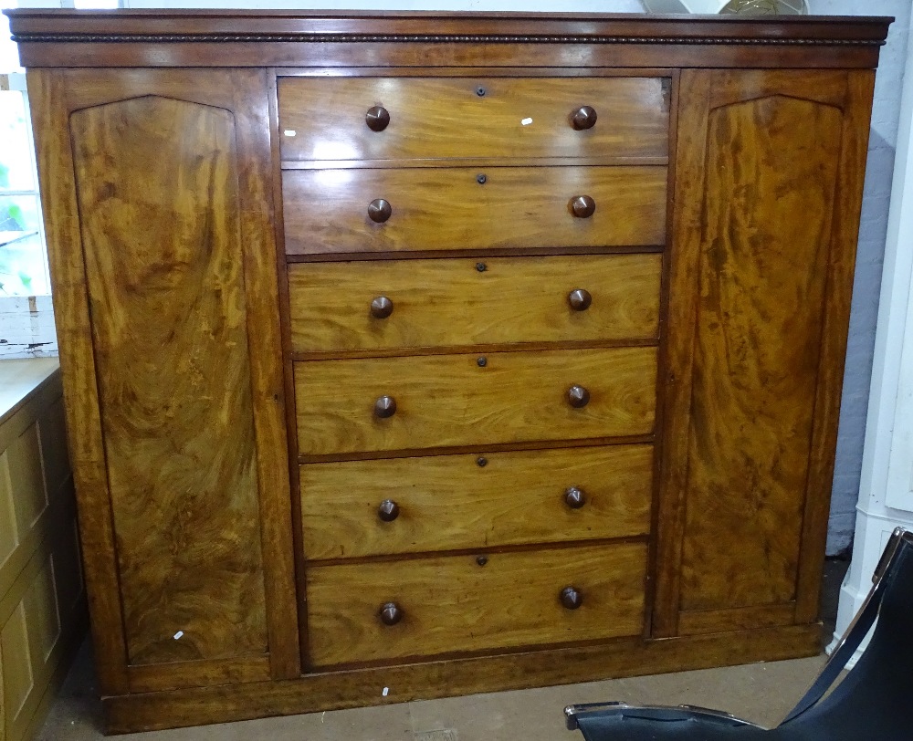 A Victorian mahogany dwarf 3-section wardrobe, the centre section fitted with a rising cupboard