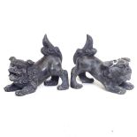 A pair of Oriental black painted brass Dogs of Fo, height 14cm