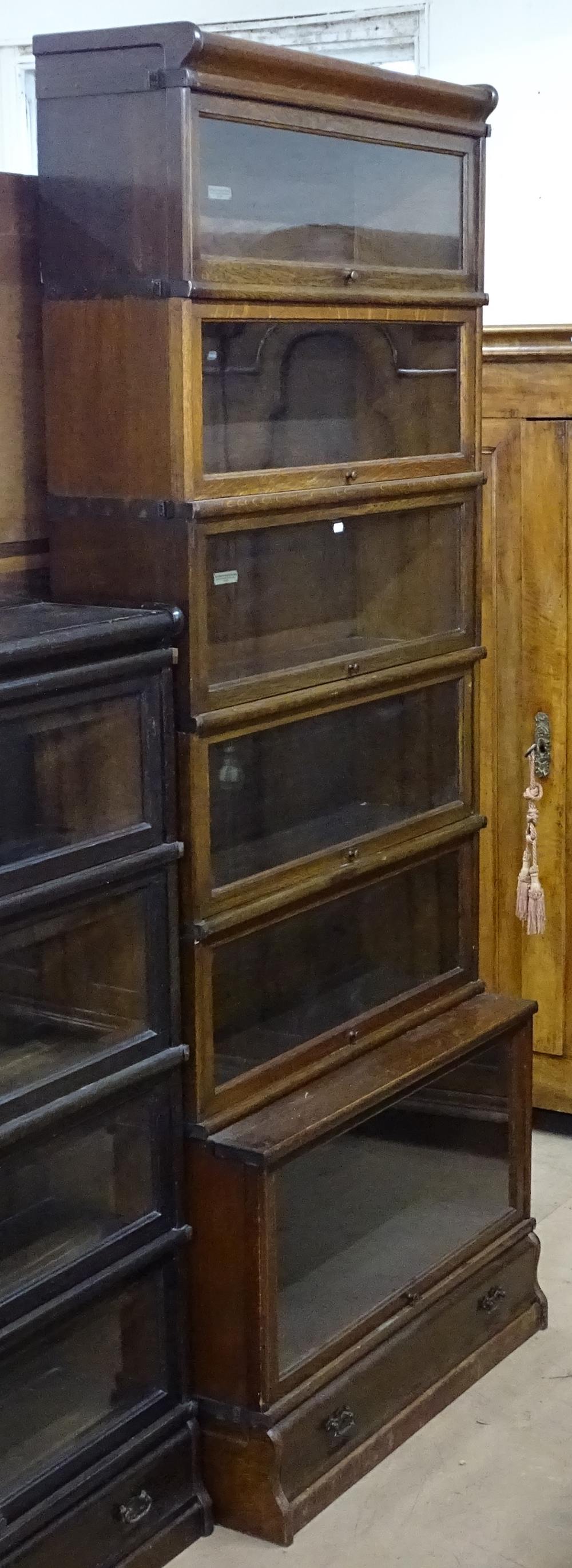 An early 20th century 6-section oak Globe-Wernicke bookcase, with drawer fitted to the base,