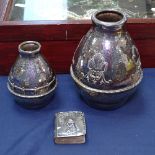 An Art Nouveau hammered silver plated vase of stylised form, a similar smaller vase, and an Art
