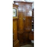 A George III mahogany corner cupboard, with 4 panelled doors, W85cm, H221cm