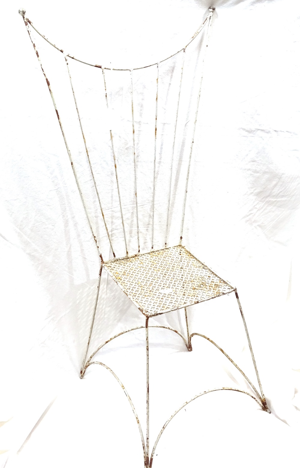 A small white painted wrought-iron doll's chair, with pierced seat and wirework wing-back, height