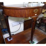 A Georgian mahogany demilune console table, with rising lid, raised on cabriole legs with pad