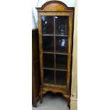 A narrow cross-banded walnut dome-top display cabinet, with single lattice-glazed door, on