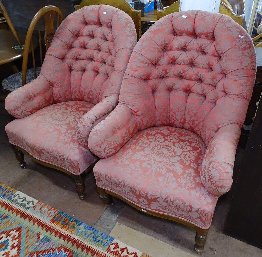 A pair of button-back upholstered armchairs, with turned mahogany legs