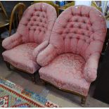 A pair of button-back upholstered armchairs, with turned mahogany legs