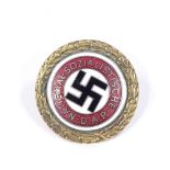 A German Second War Period NSDAP Gold Party badge with enamelled centre, diameter 30mm