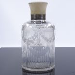 A cut-glass perfume bottle with ivory-mounted silver screw top and etched floral swags, hallmarks