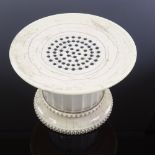 A 19th century carved turned and fluted ivory pounce pot, diameter 10cm, height 6.5cm There are a