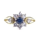 An 18ct gold sapphire and diamond cluster ring, diamond set shoulders, total diamond content