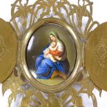 A 19th century hand painted porcelain plaque, depicting Mary and the infant Christ, in ornate
