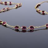 A 14ct gold oval-cut garnet line necklace, hallmarks London 2016, necklace length 66cm, 22.4g Very