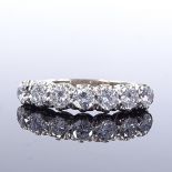 An 18ct white gold 7-stone diamond half-hoop ring, total diamond content approx 1.05ct, maker's