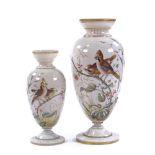 A graduated pair of Victorian milk glass vases, with hand painted designs of exotic birds and