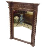 A 19th century carved oak-framed wall mirror, with barley twist columns, height 46", width 35"