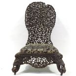 A Burmese hardwood low chair with carved and pierced fan-shaped back