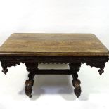 A Victorian Carolean style oak library table, with end frieze drawers, raised on heavy carved scroll