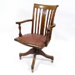 An Edwardian mahogany and satinwood inlaid revolving office desk chair