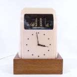 A Vitascope pink Bakelite-cased clock, circa 1930s, with rolling ship automaton, on later wooden