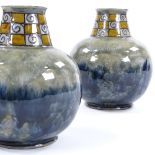 A pair of Royal Doulton squat vases, mottled blue glaze with chequered swirl flared neck,