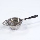 An Elizabeth II silver tea strainer and bowl, turned wood handle with beaded border, by Hampton
