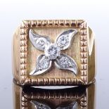 A 14ct gold diamond panel signet ring, central diamond set floral panel, total diamond content
