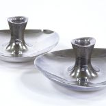 A pair of Suomen Hopeateollisuus Oy Finnish silver candlesticks, stylised form, designed by Tapio