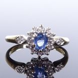 An unmarked gold sapphire and diamond cluster ring, diamond set shoulders, settings test as 9ct,