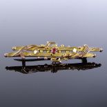 A Victorian 9ct gold ruby double-bar brooch, brooch length 47.4mm, 2.1g Good overall condition, no
