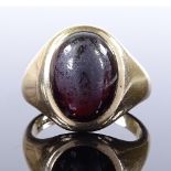 A 9ct gold cabochon garnet signet ring, hallmarks London 1966, setting height 18.6mm, size R, 9.7g