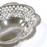 A George V silver bonbon dish, oval lobed form with pierced sides and foliate border, by S