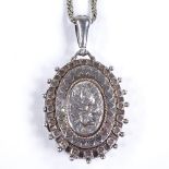A Victorian silver pendant locket necklace, on white metal chain, relief embossed and engraved
