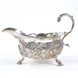 A George II silver sauce boat, relief embossed floral and foliate decoration with acanthus leaf C