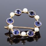 An Edwardian 15ct gold colour change spinel and pearl circular brooch, spinels changing from