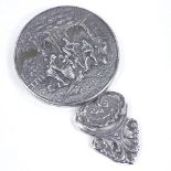 A Danish unmarked silver handbag mirror, relief embossed orchard scene, length 11cm Very good