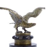 A bronze eagle design car mascot, early 20th century, unsigned, on original Bakelite screw cap base,
