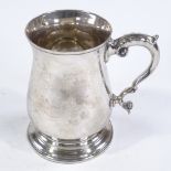 An Elizabeth II silver pint mug, of plain baluster form with acanthus leaf handle, by C J Vander