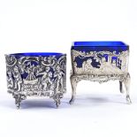 2 19th century German silver salt bowls, pierced and relief embossed cherub decoration with blue