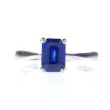 An 18ct white gold solitaire sapphire ring, emerald-cut sapphire approx 1ct, setting height 7.4mm,