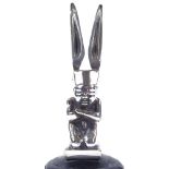 An Art Deco chrome-plate bronze car mascot in the form of a kneeling figure wearing a winged hat,