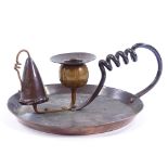 An Arts and Crafts copper chamber stick, circa 1900, with spiral twist handle, dish diameter 17cm