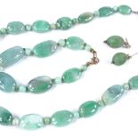 A modern polished jade and composition demi-parure, comprising jade necklace and bracelet with