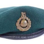 A military green beret with badge