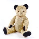 A 1950s gold plush straw-filled Sooty Teddy Bear, black pad hands, feet and ears, with growler,