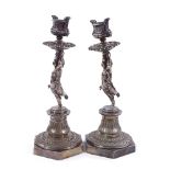 A pair of Victorian Elkington plate candlesticks supported by cherubs, height 27cm One stick has