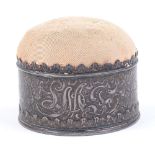 TIFFANY & CO. - an American sterling silver circular pin cushion, floral relief embossed decoration,