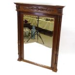 A French carved walnut-framed wall mirror, with fluted twin columns, height 5'8", width 3'7"