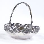 A German silver swing-handled basket, pierced and relief embossed floral border and handle, diameter
