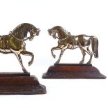 A pair of 19th century relief moulded brass horse design door stops on ogee wooden bases, base