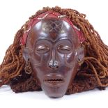 An African carved wood mask with rope braided hair, mask height 19cm Good original condition